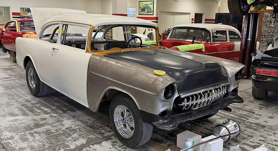 Partially assembled 1955 Chevy project in a garage.