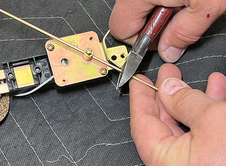 Cutting the excess length of the float rod.