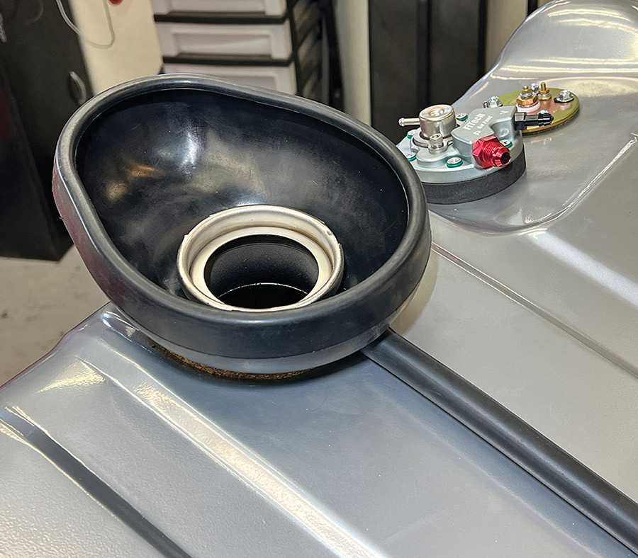 Rubber filler neck seal and overflow hose assembly.