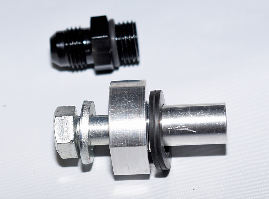 Bung and bolt assembly for tank return line.