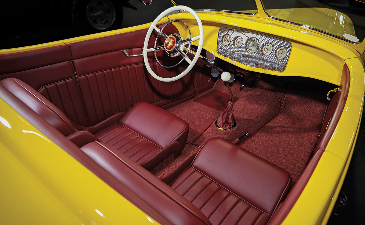 High angle view of yellow roadster body and Oxblood leather interior.