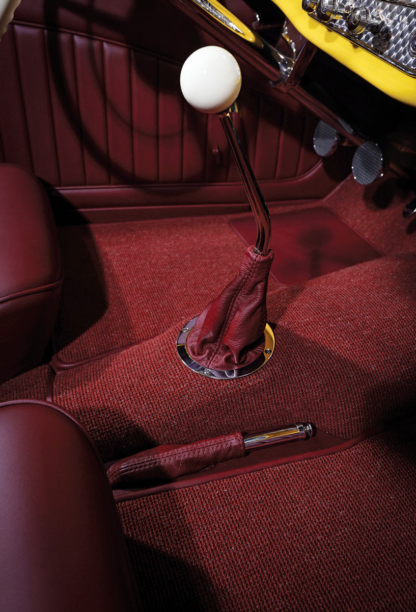 Lokar shifter with white knob and red leather boot.