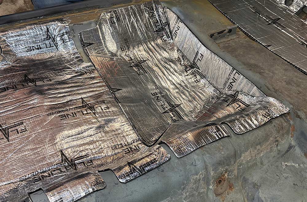 View of completed insulation coverage on rear car floor.