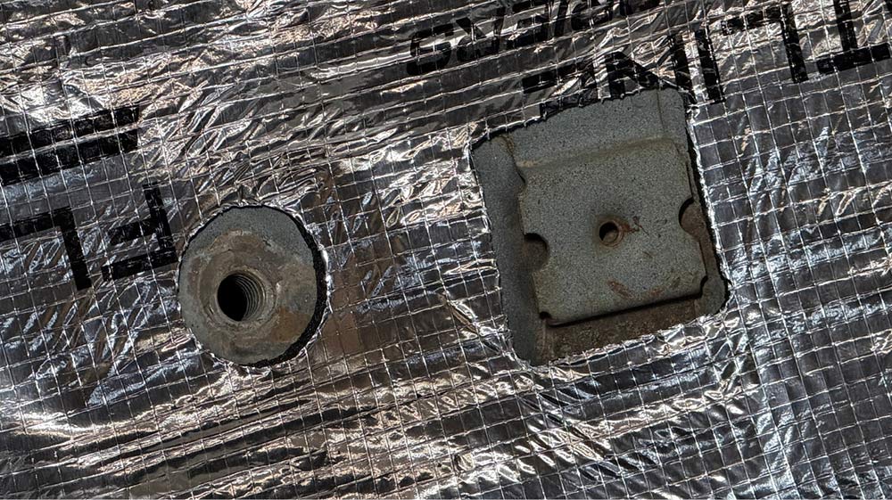 Detail of a square and round precut insulation hole.
