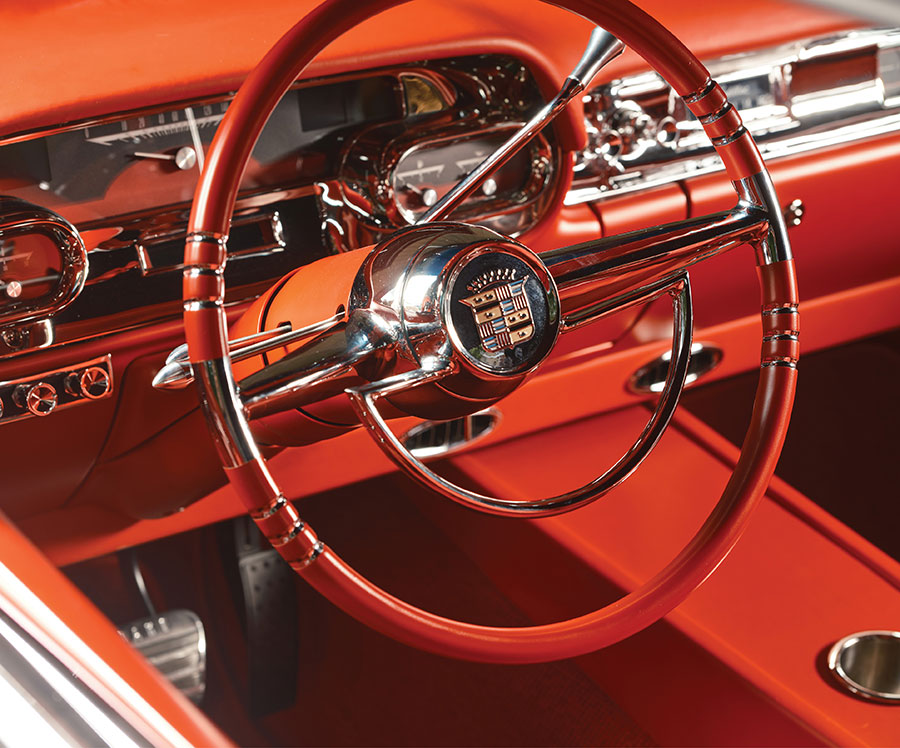 Steering wheel and dash detail with custom red leather padding