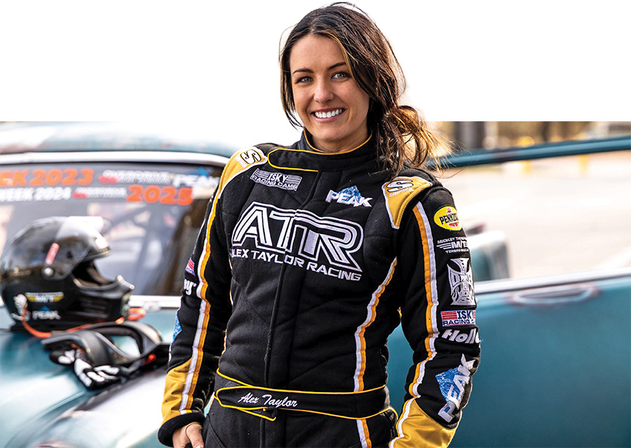 Alex Taylor smiling in her black and yellow racing suit.