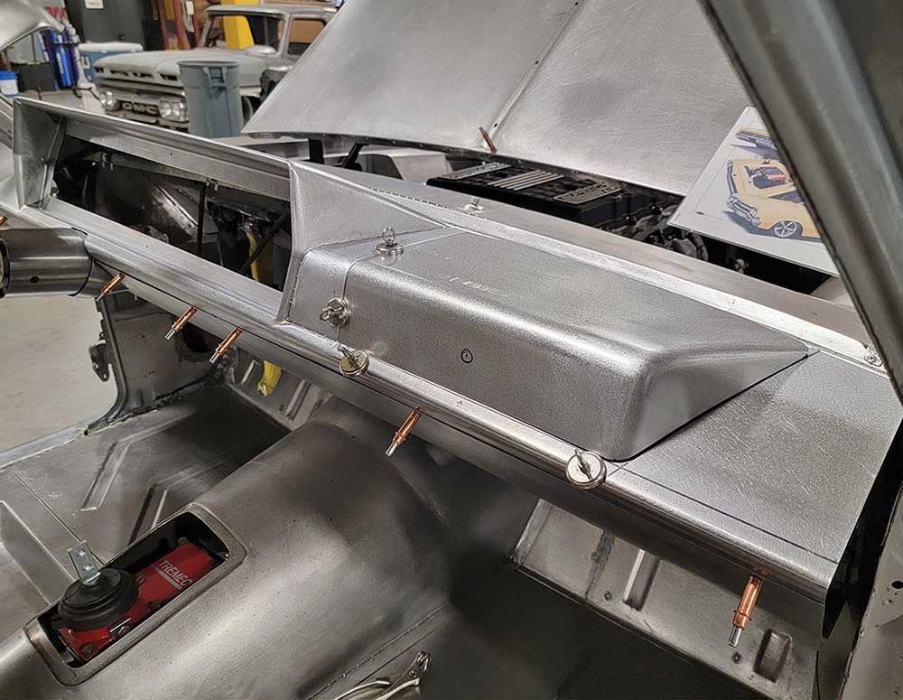 Magnets holding panels for fitting the upward-hinging glovebox door.