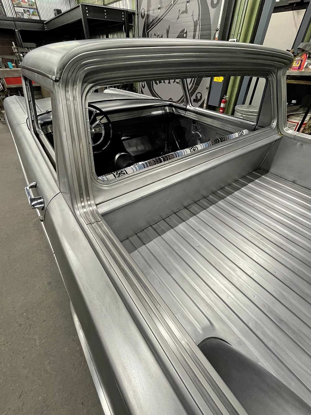 Custom stainless steel bed trim fitted to the Ranchero cab.