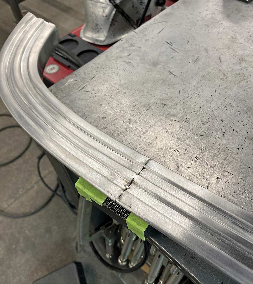 Clamping the stainless trim onto the body to prepare for welding.