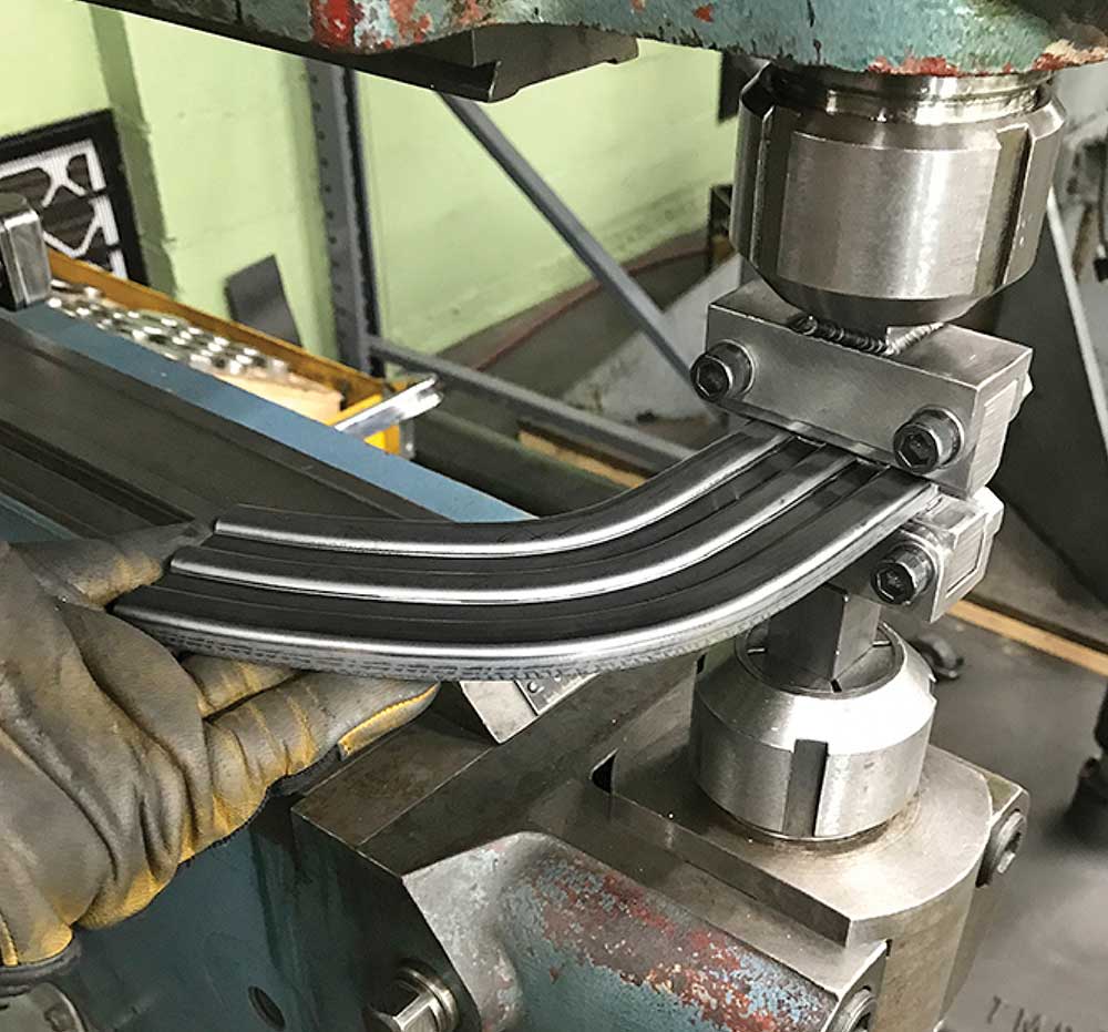 Forming bead details in the stainless trim using a Pullmax machine.