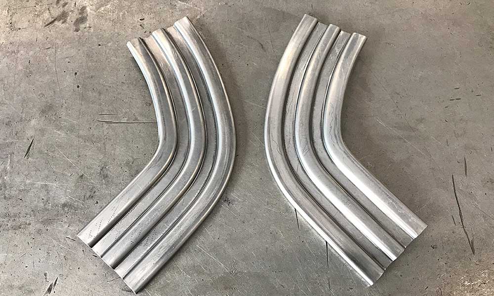 A pair of completed custom-formed stainless corner trim pieces.