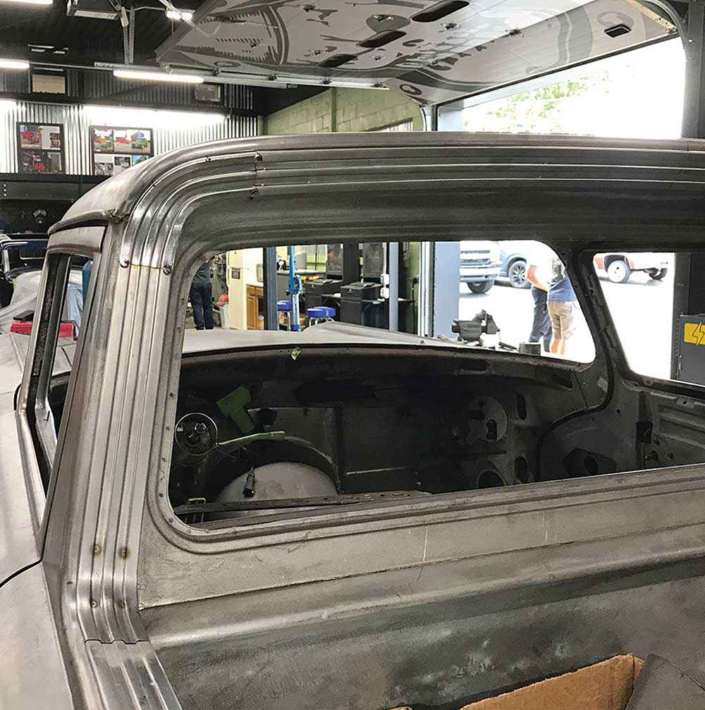 Tack-welding the formed stainless trim around the rear window frame.