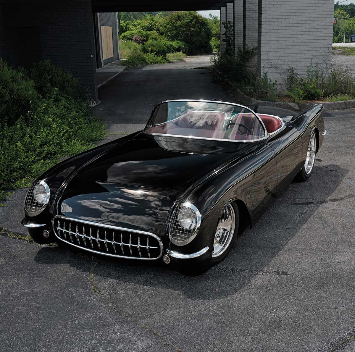 Three-quarter front view of the black 1954 Corvette roadster.