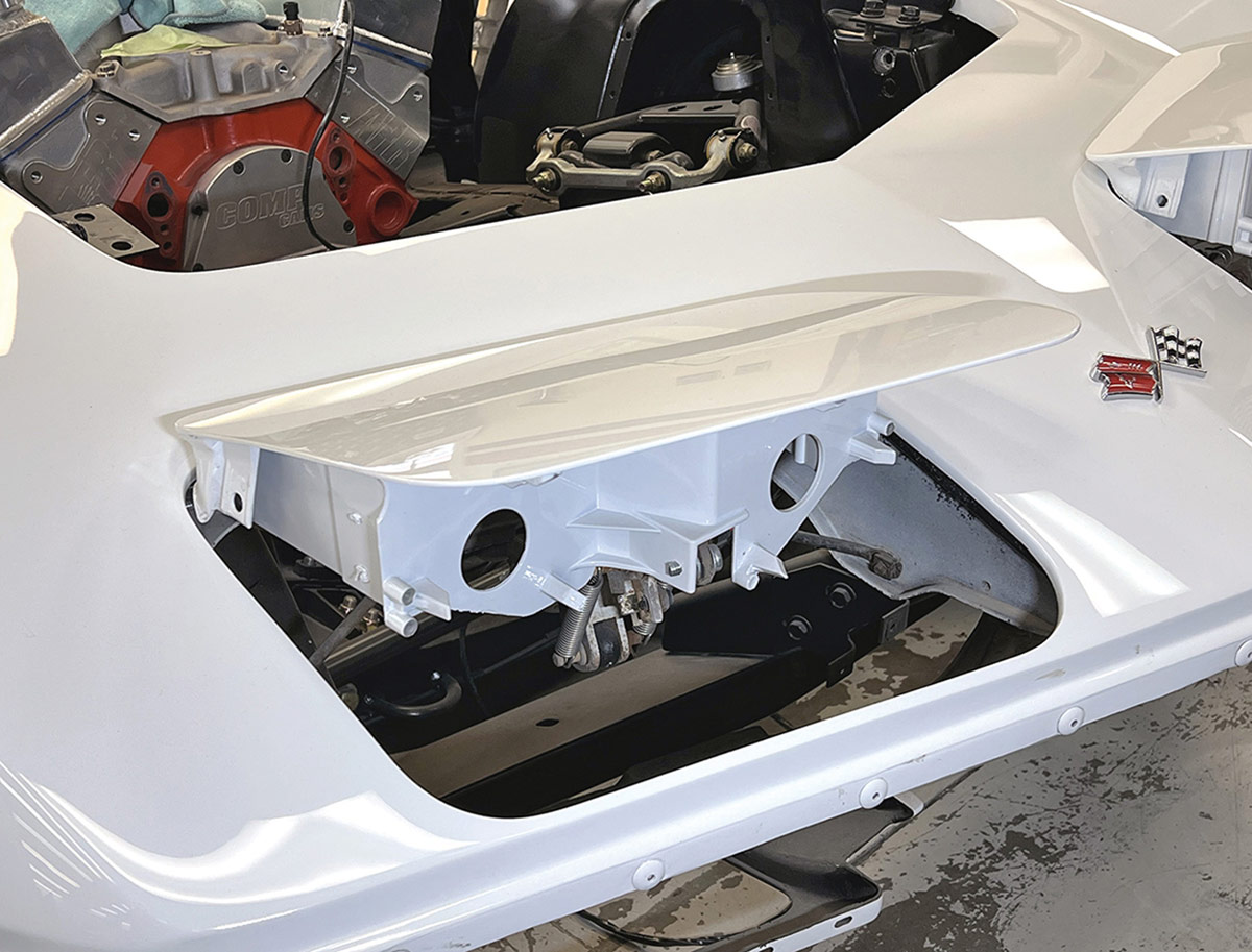 Headlight bucket opening with original hardware removed.