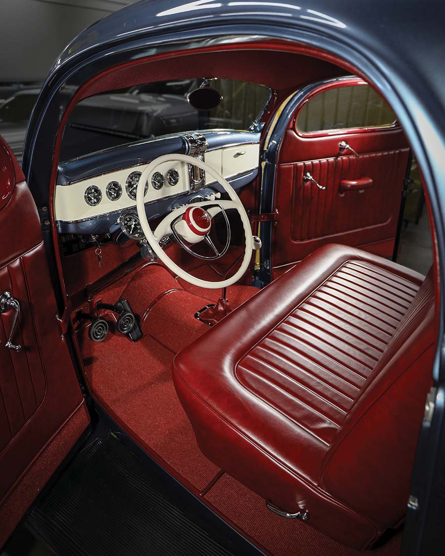 Interior featuring maroon leather upholstery and customized Zephyr steering wheel.
