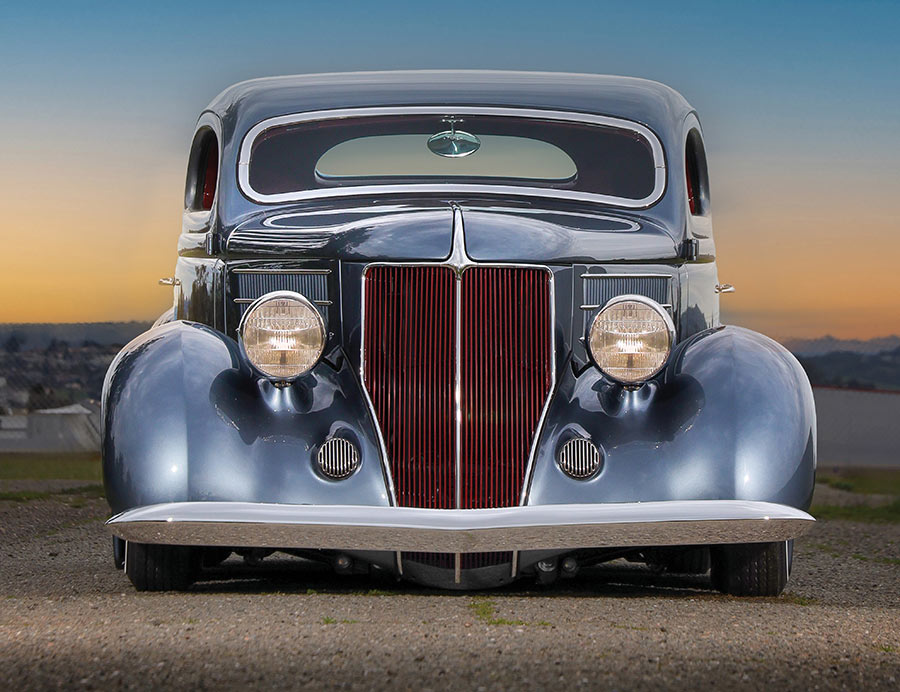 Front-end view highlighting the maroon grille and lowered headlights.