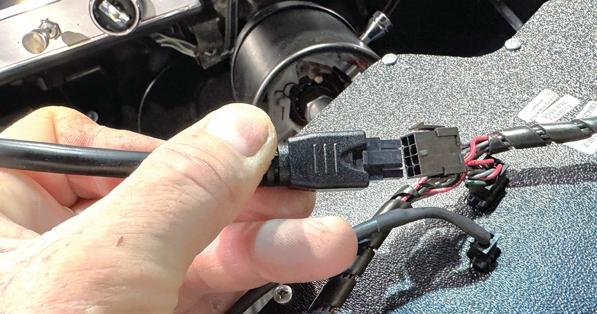 Snapping gauge harnesses together before reinstallation of the panel.