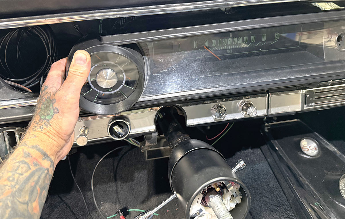 Carefully reinserting the instrument panel into the dashboard housing.