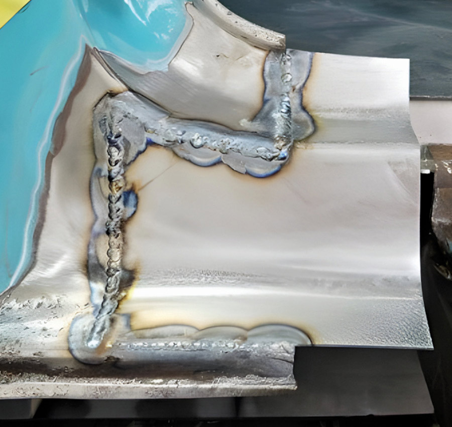 Welding a new metal patch onto a rocker panel