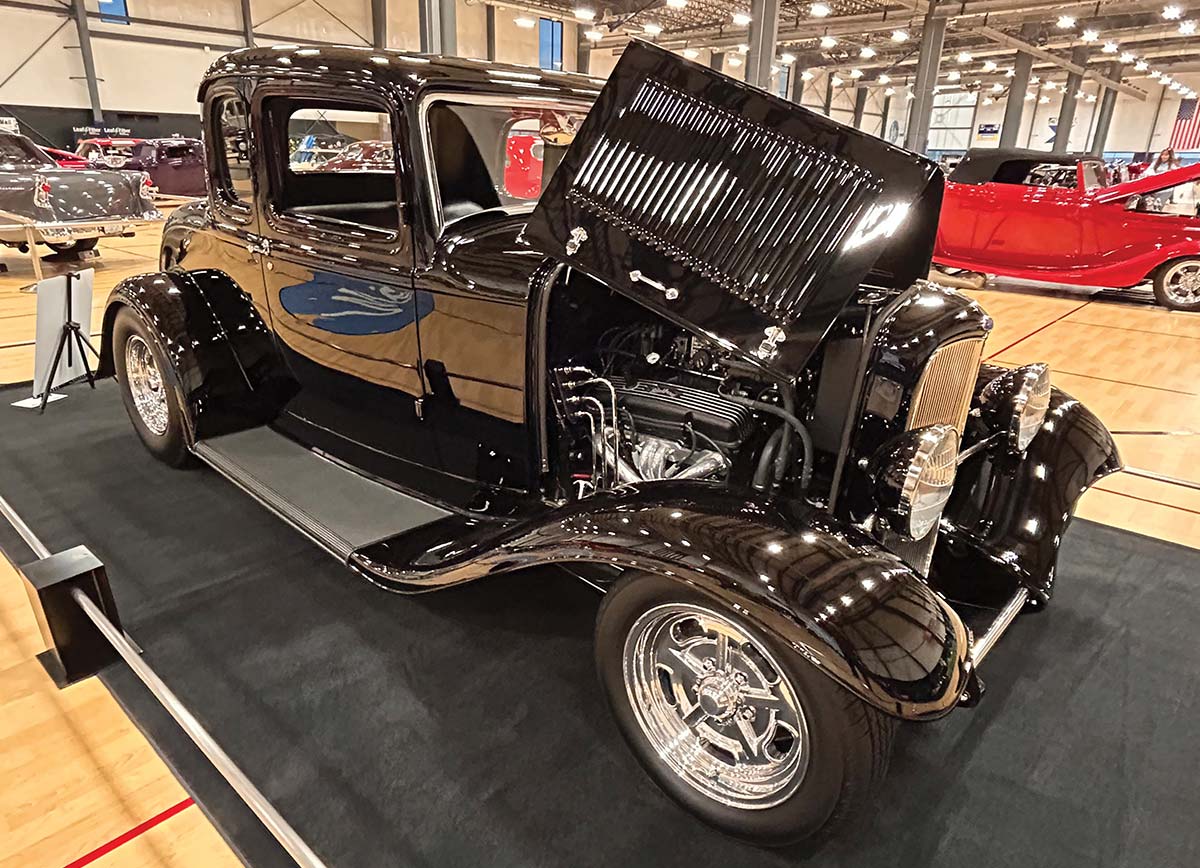 Black 1932 Ford five-window coupe with open hood