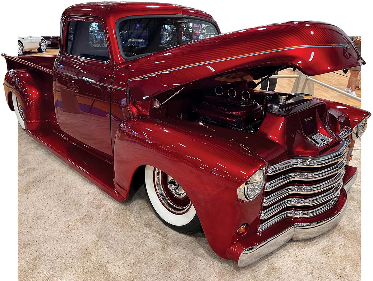 Red 1950 Chevy pickup with open hood on display<br />
