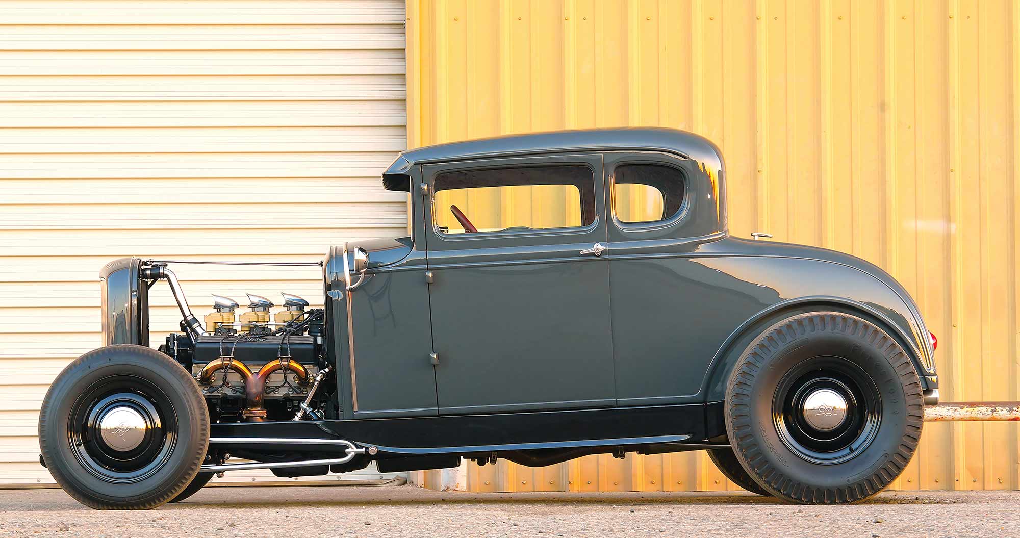 Side profile of chopped 1930 Ford highboy with open engine.