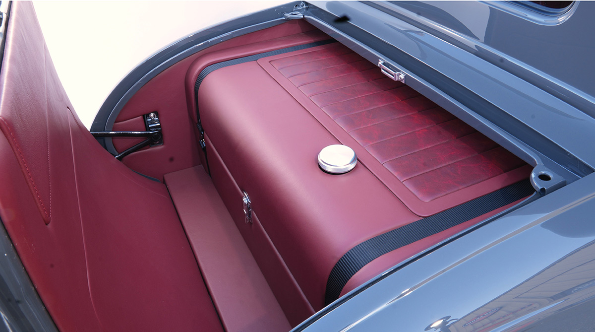 Custom fuel tank disguised as vintage luggage in rumble seat.