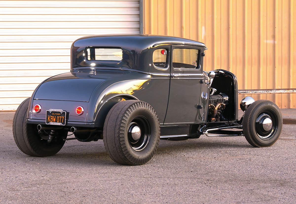 Rear three-quarter view of gunmetal gray 1930 Ford coupe.