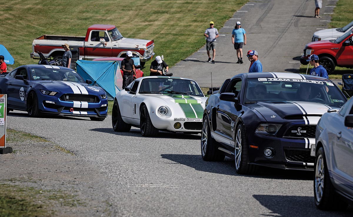 Endless parade of performance cars entering the show.
